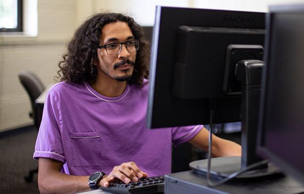 Student Working on the Computer in the Library 