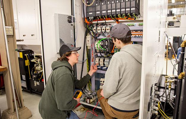 Two Students working on Service Technician Equipment at Anoka Technical College.